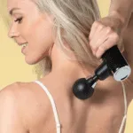 girl massage her back with massage gun