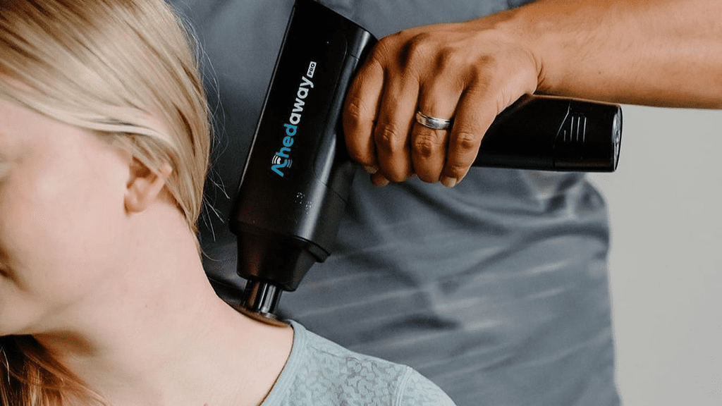 massage gun in work on neck zone