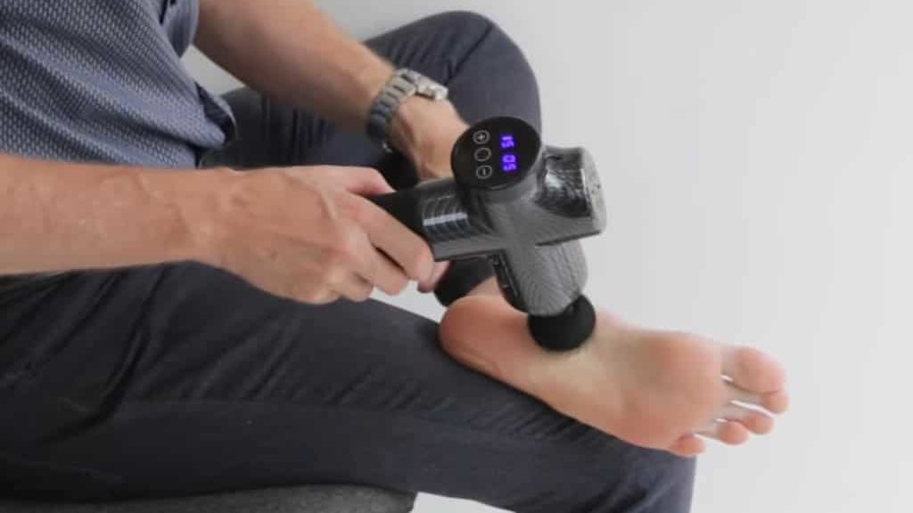 Foot massage with a massage gun