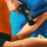 Massage the leg with a massage gun