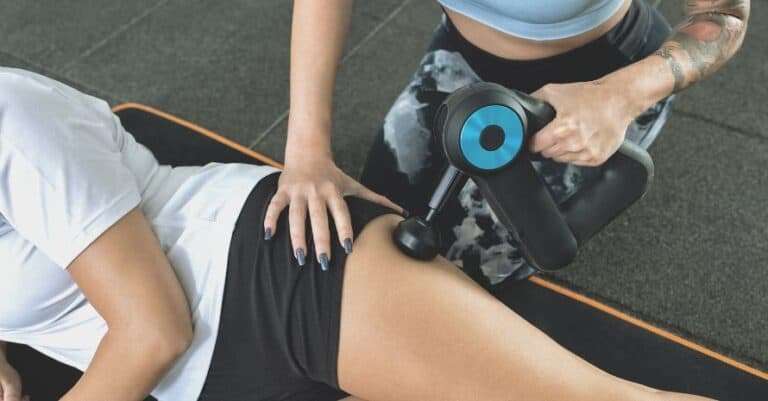massage the thigh with a massage gun