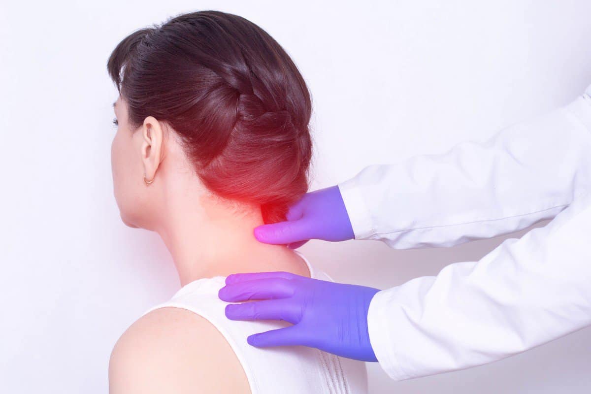 Woman is being checked for a pinched nerve