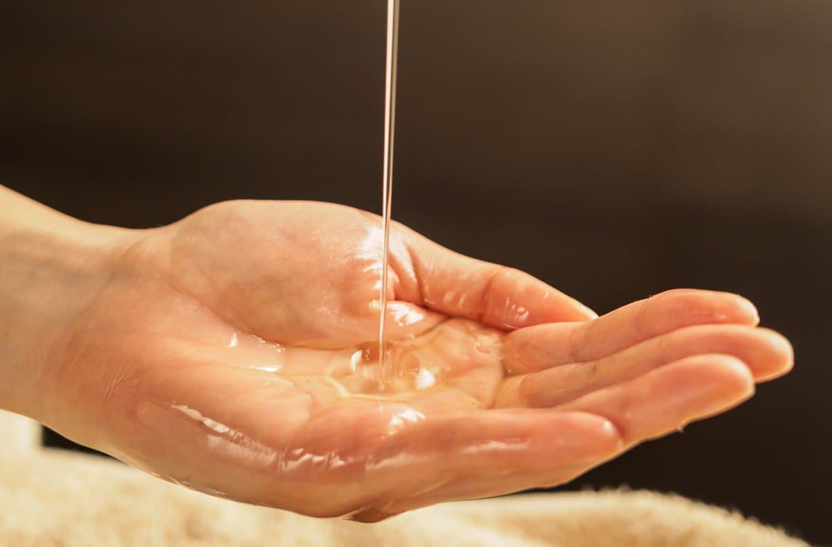 massage oil is poured into the hand