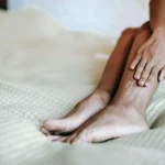 A lady massaging her own calf