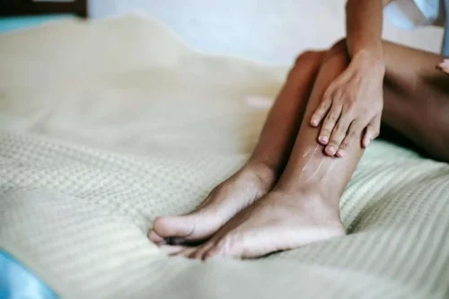 A lady massaging her own calf