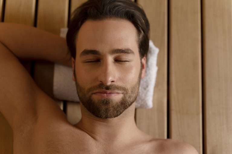 Man relaxing with his eyes closed during a massage