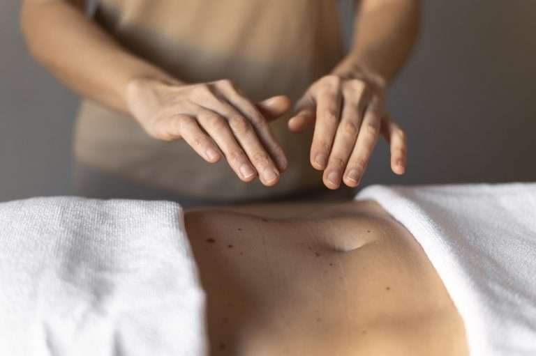 Massage therapist's hands on a client's back