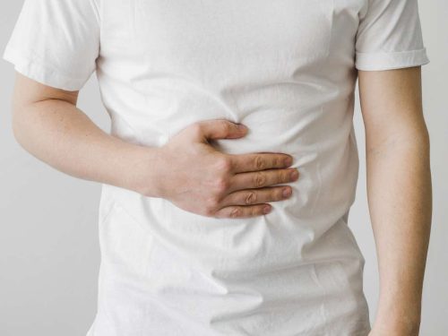 man clutching at his stomach in discomfort