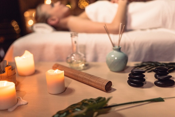 tantric-massage-spa-setting Calm spa setting with candles and massage tools for tantric massage
