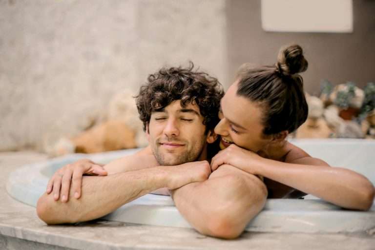 Smiling woman massaging her partner's shoulders