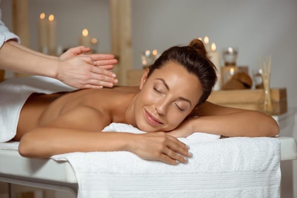 comfortable-massage-table-experience Woman relaxing comfortably on a padded massage table during a wellness massage session