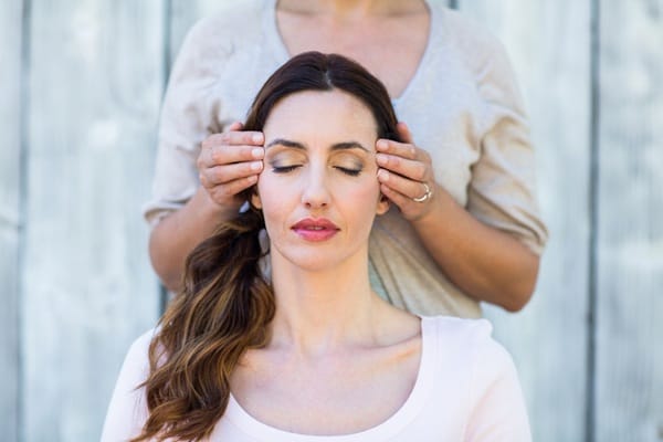 headache pressure points 28592 (4) woman receiving a temple massage headache pressure point