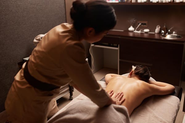 Traditional Japanese massage therapy room with futon and shoji screens