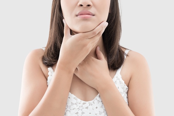 person holding neck with swollen lymph nodes during illness