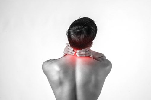 woman experiencing neck pain after massage side effects