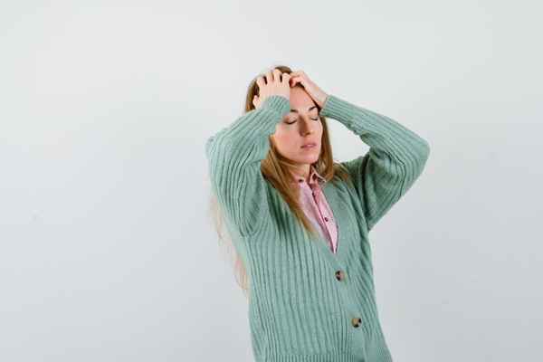 person feeling dizzy after massage treatment