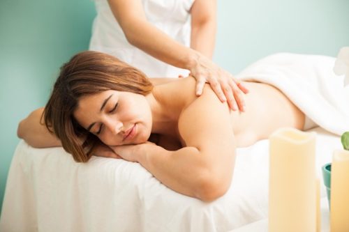 woman receiving gentle back massage in calm spa setting relaxation and wellness therapy