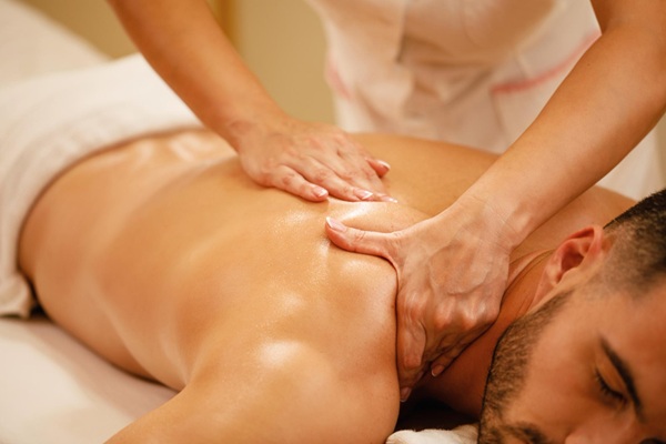 Relaxed man resting peacefully after massage treatment