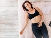 Woman relaxing comfortably in bed representing labia massage, self-care, and female wellness.